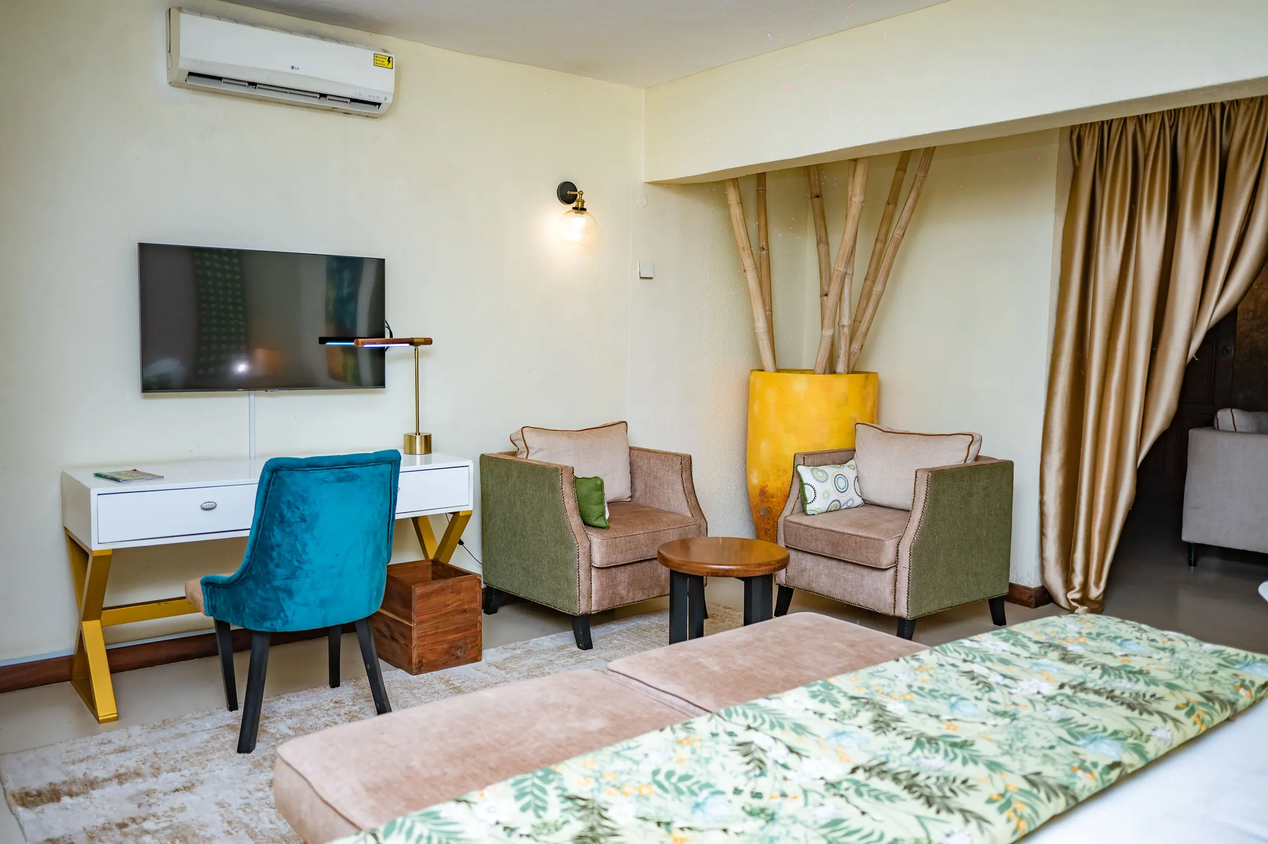 The lounge of the VIP Suite at The Emin Pasha Hotel & Spa, with a television and armchairs