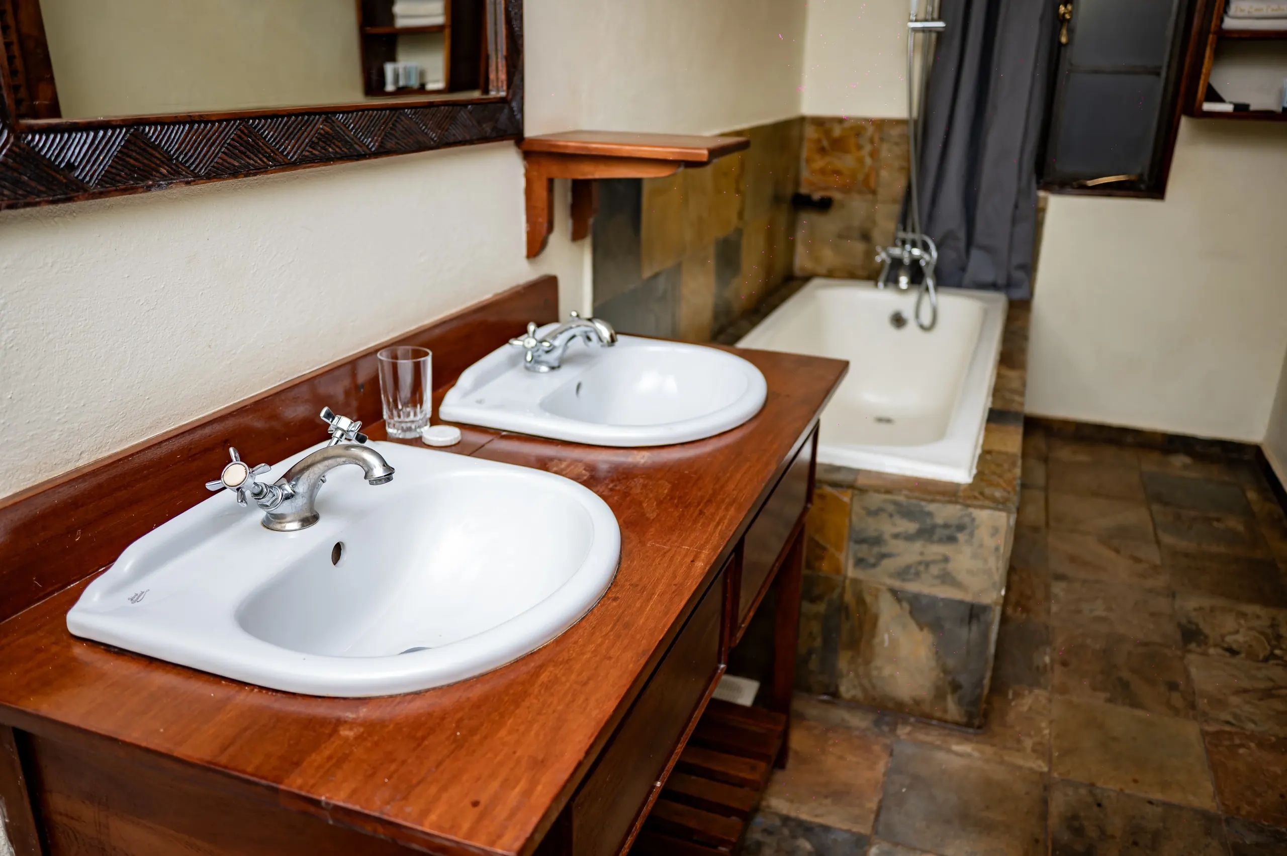 The bathroom of the VIP Suite at The Emin Pasha Hotel & Spa, twin basins on a mahogany vanity
