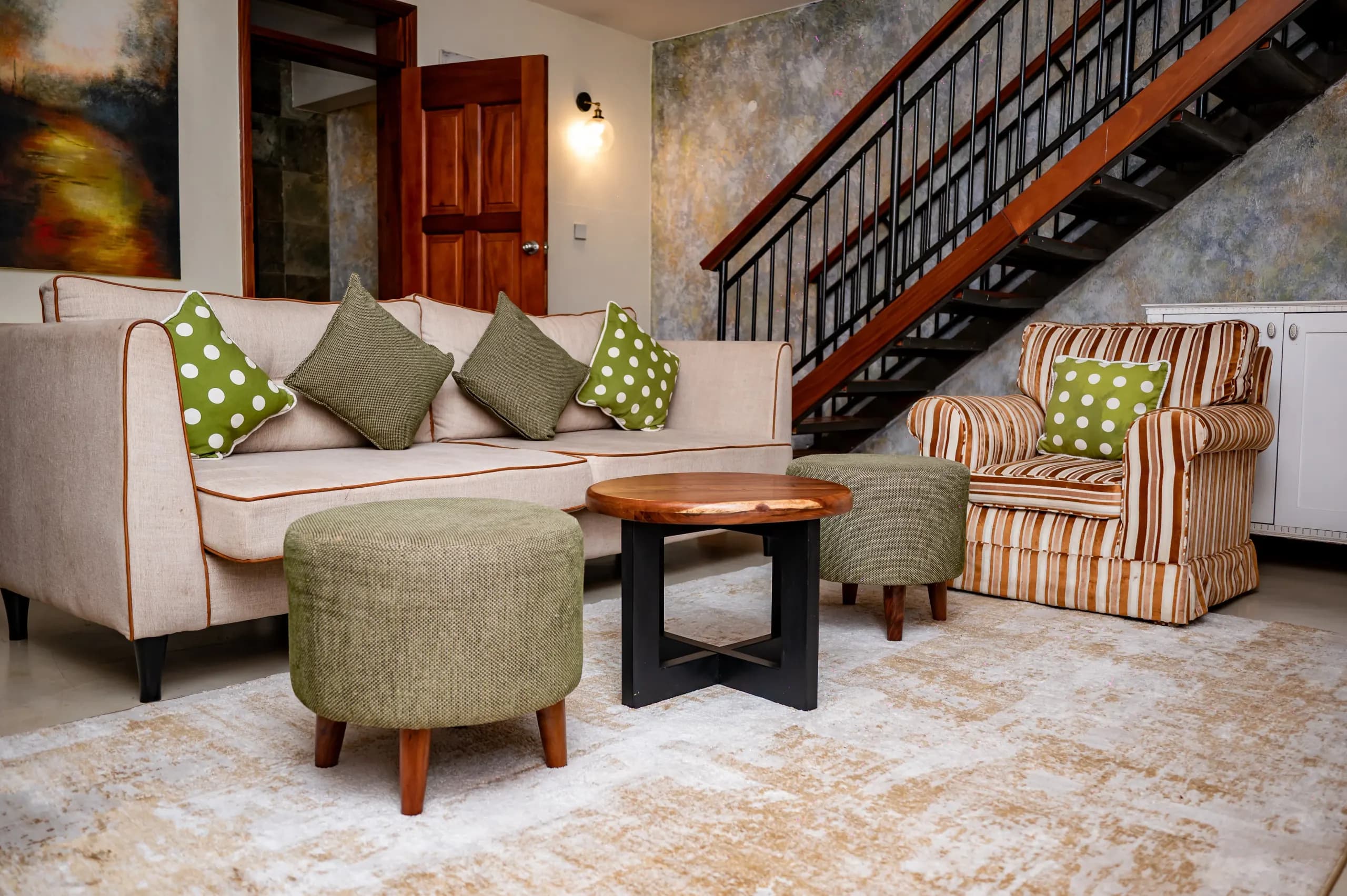 The lounge of the VIP Suite at The Emin Pasha Hotel & Spa, beneath the stair to its upper floor