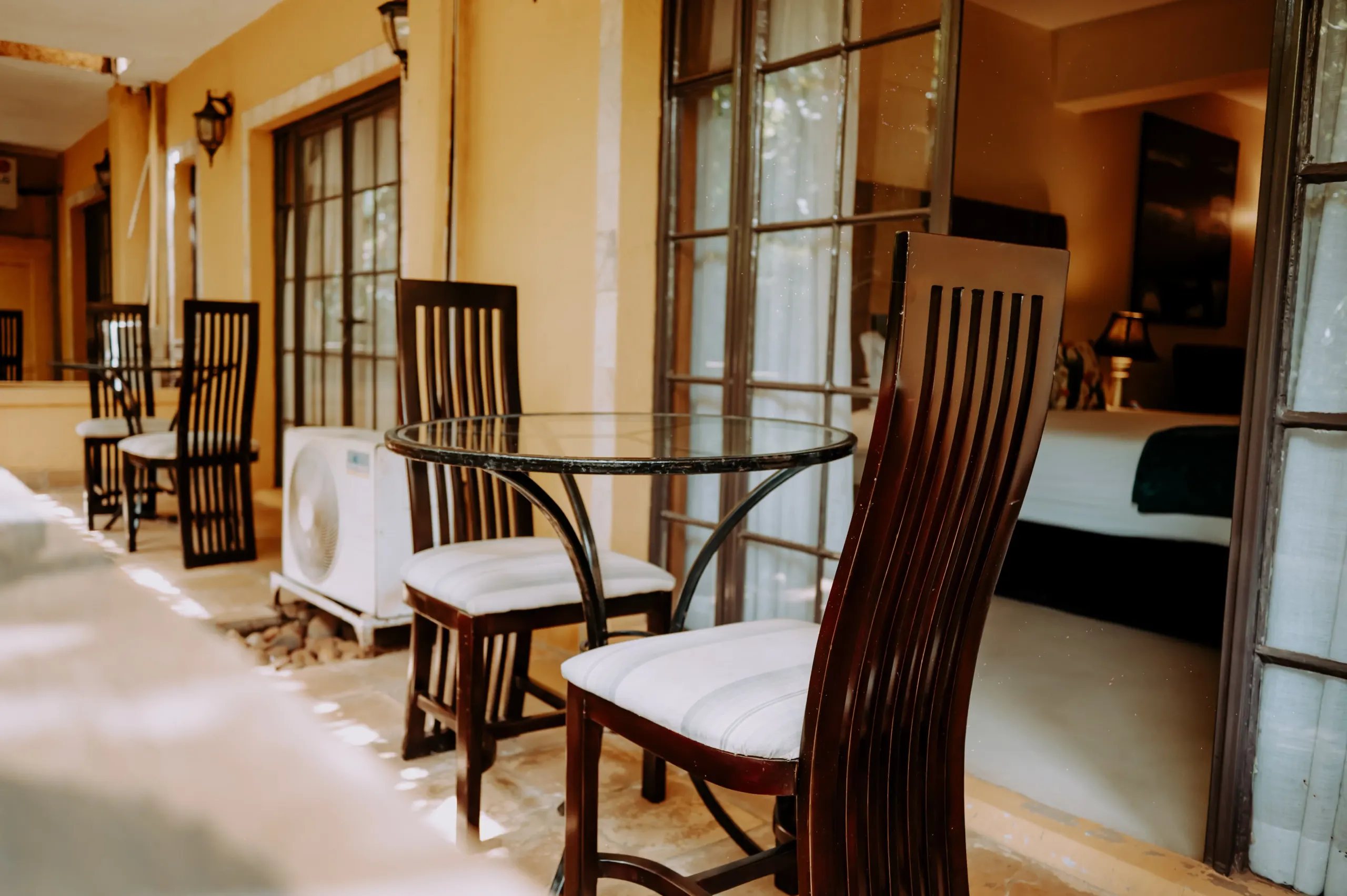 The dining table and high-backed chairs in a Deluxe Suite at The Emin Pasha Hotel & Spa