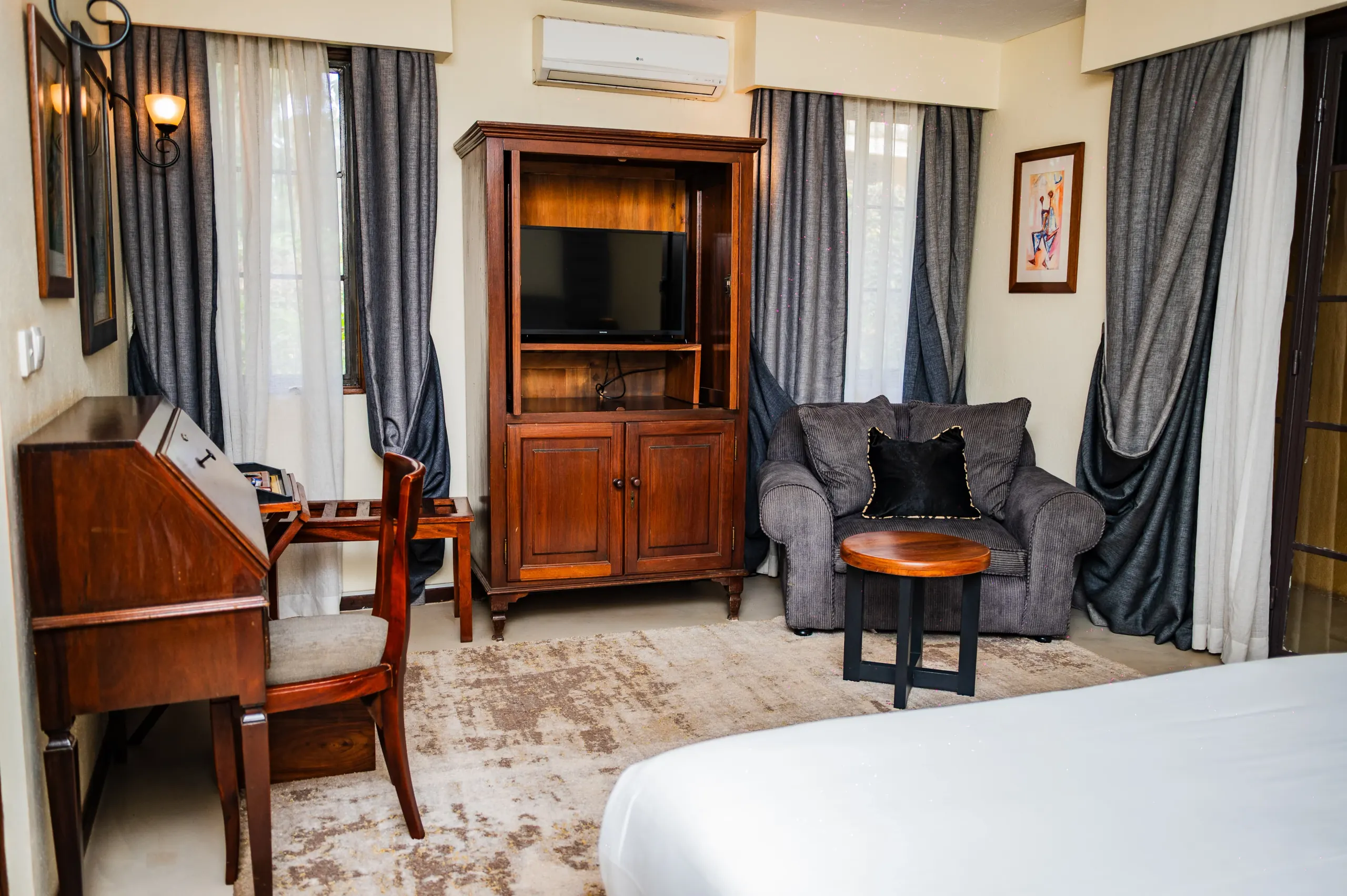A writing desk and armchairs in a Deluxe Room