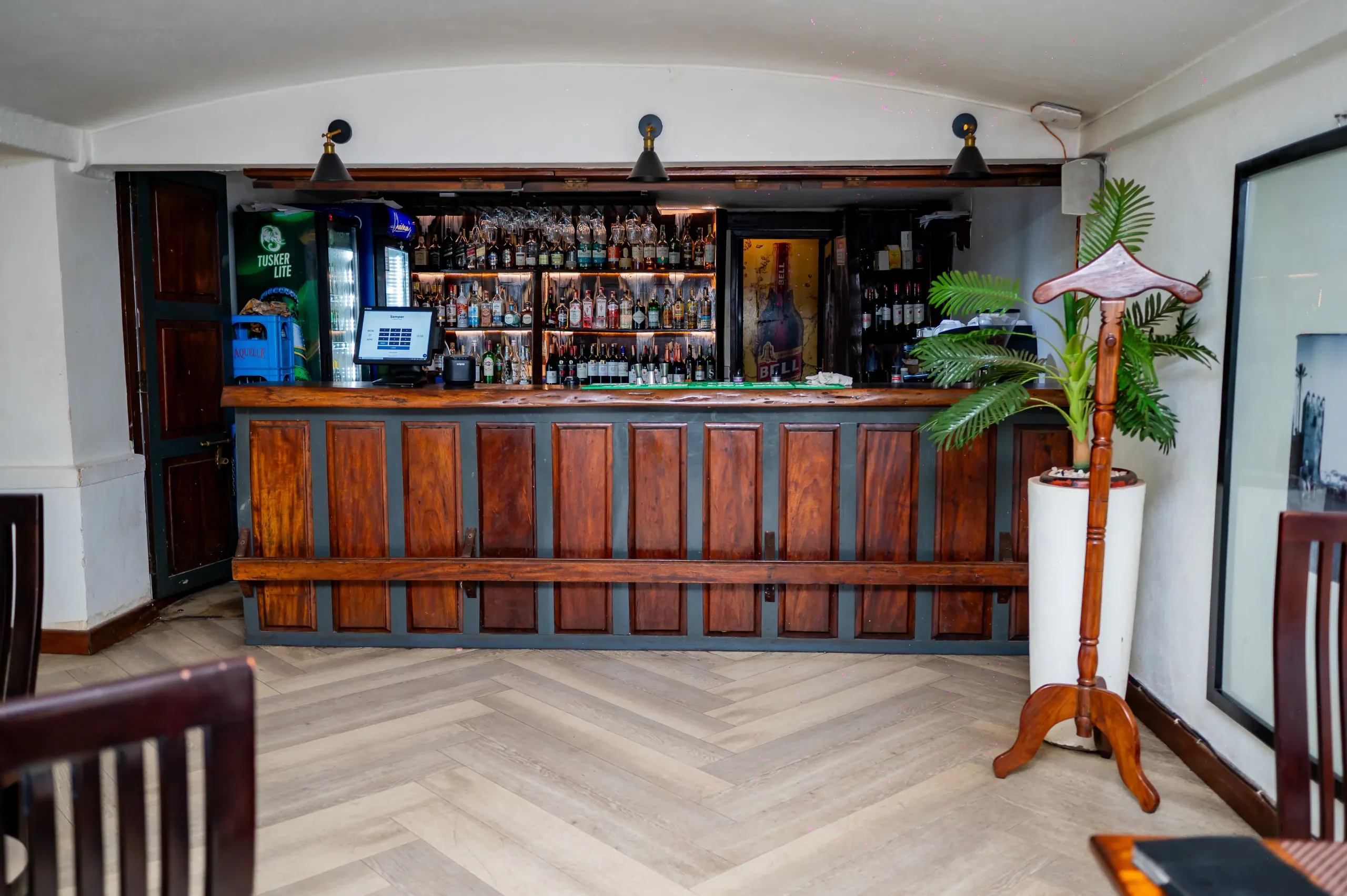 The Manutea bar head-on, its bottle wall lit behind