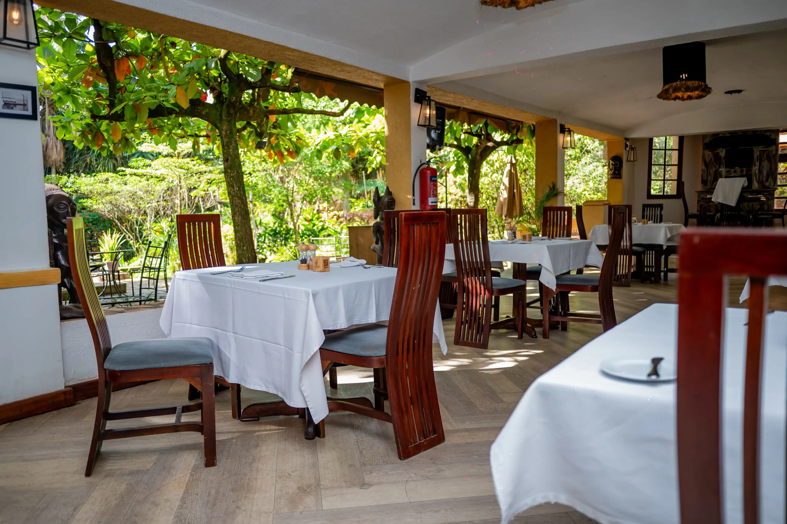 Equatoria's tables beneath the star-fruit tree