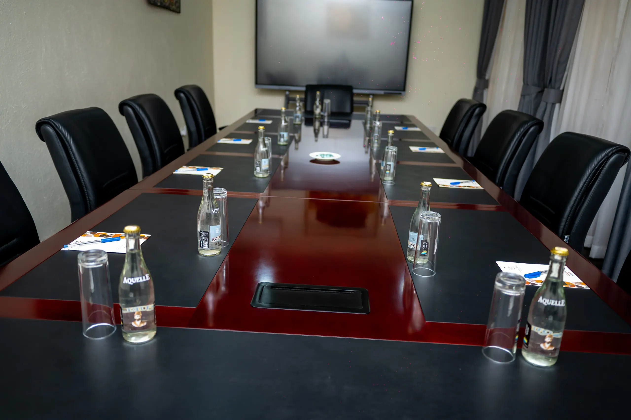 The Boardroom table with the curtained window wall behind