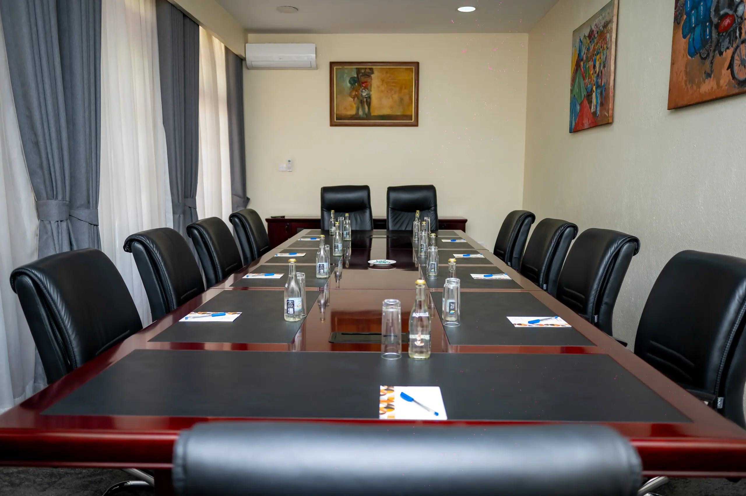 The Boardroom table seen down its full length toward the display