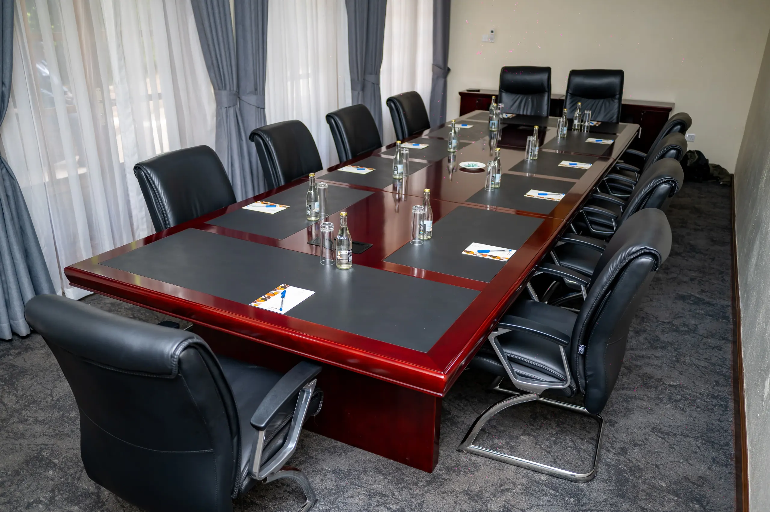 Daylight across The Boardroom table through sheer curtains