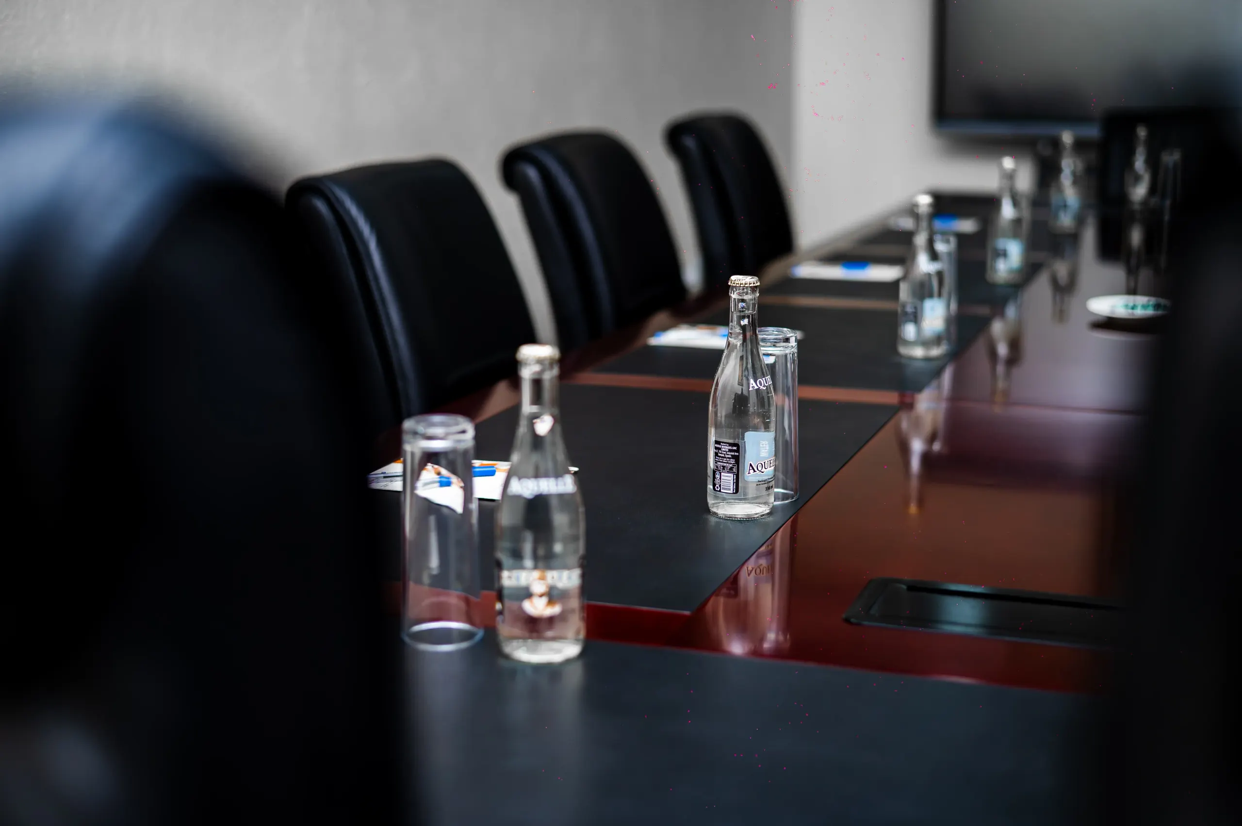 Water and glasses laid down The Boardroom table