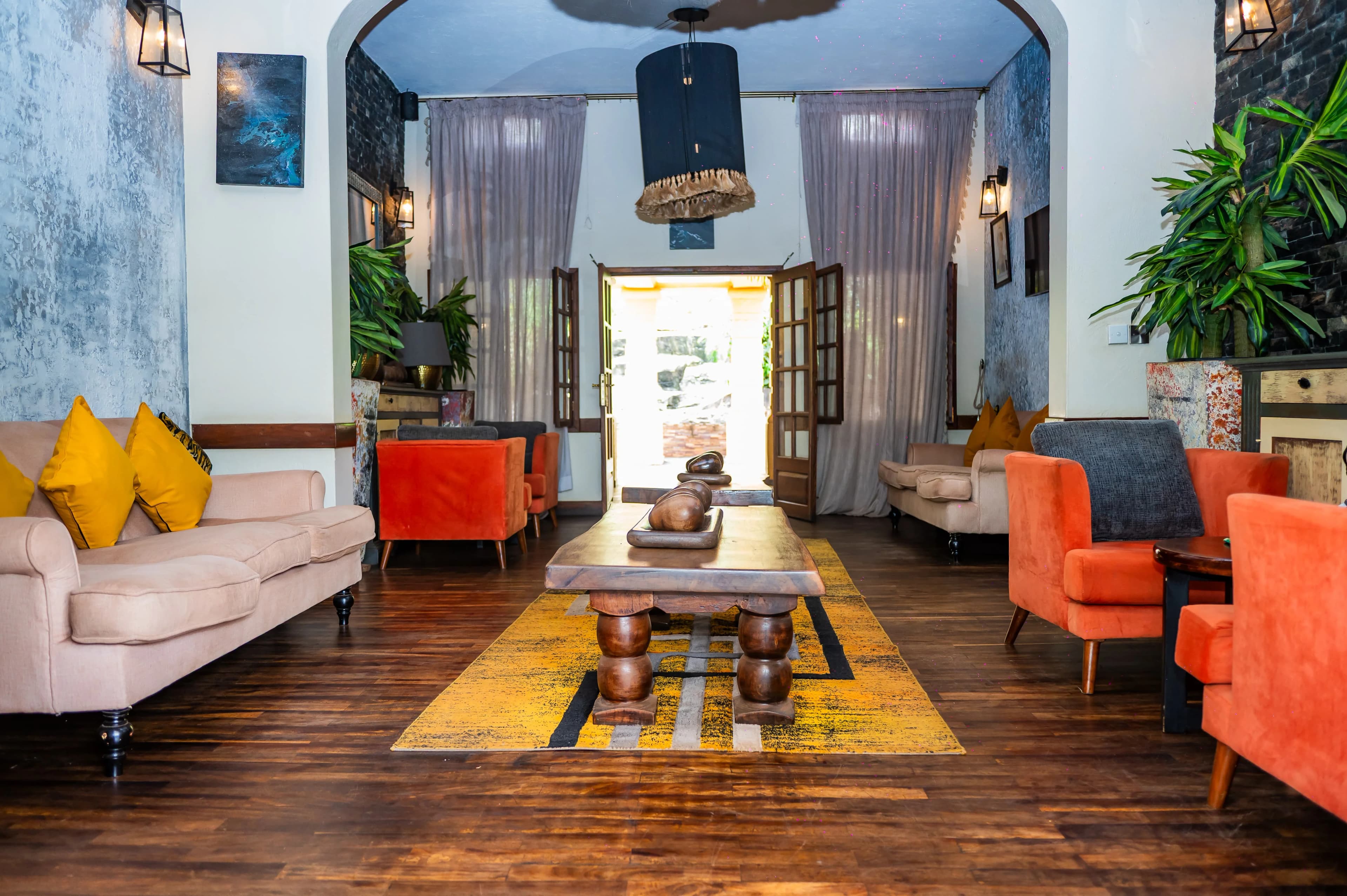 Guests in armchairs beside the lit fireplace in the Acropole Lounge