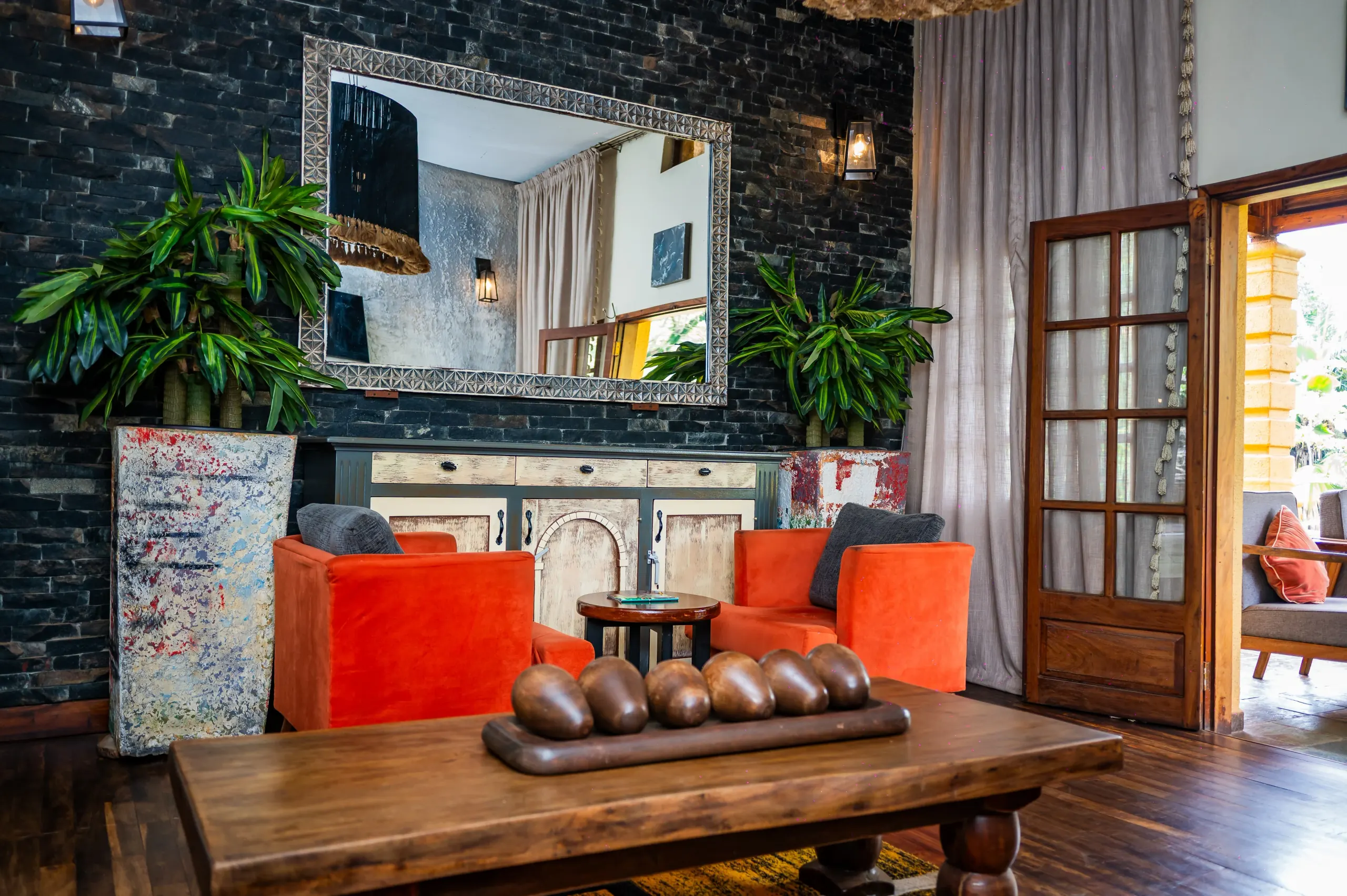 Orange velvet armchairs against the lobby's dark stone wall