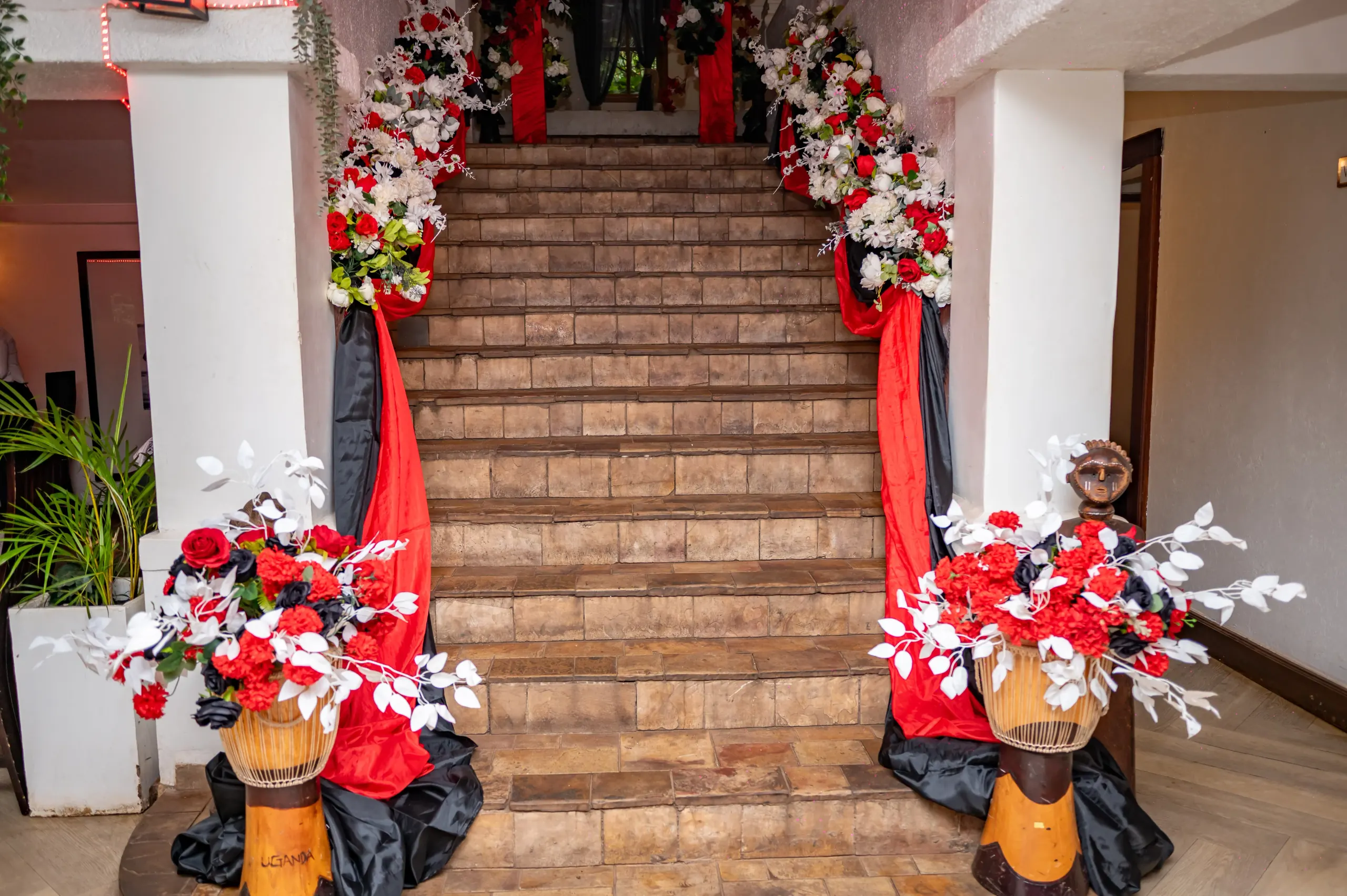 The main staircase dressed with a floral arch for a private celebration