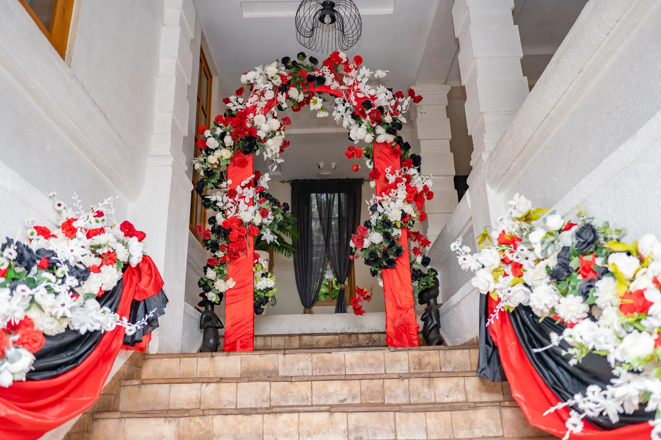 A floral arch over the doorway at the head of the stairs