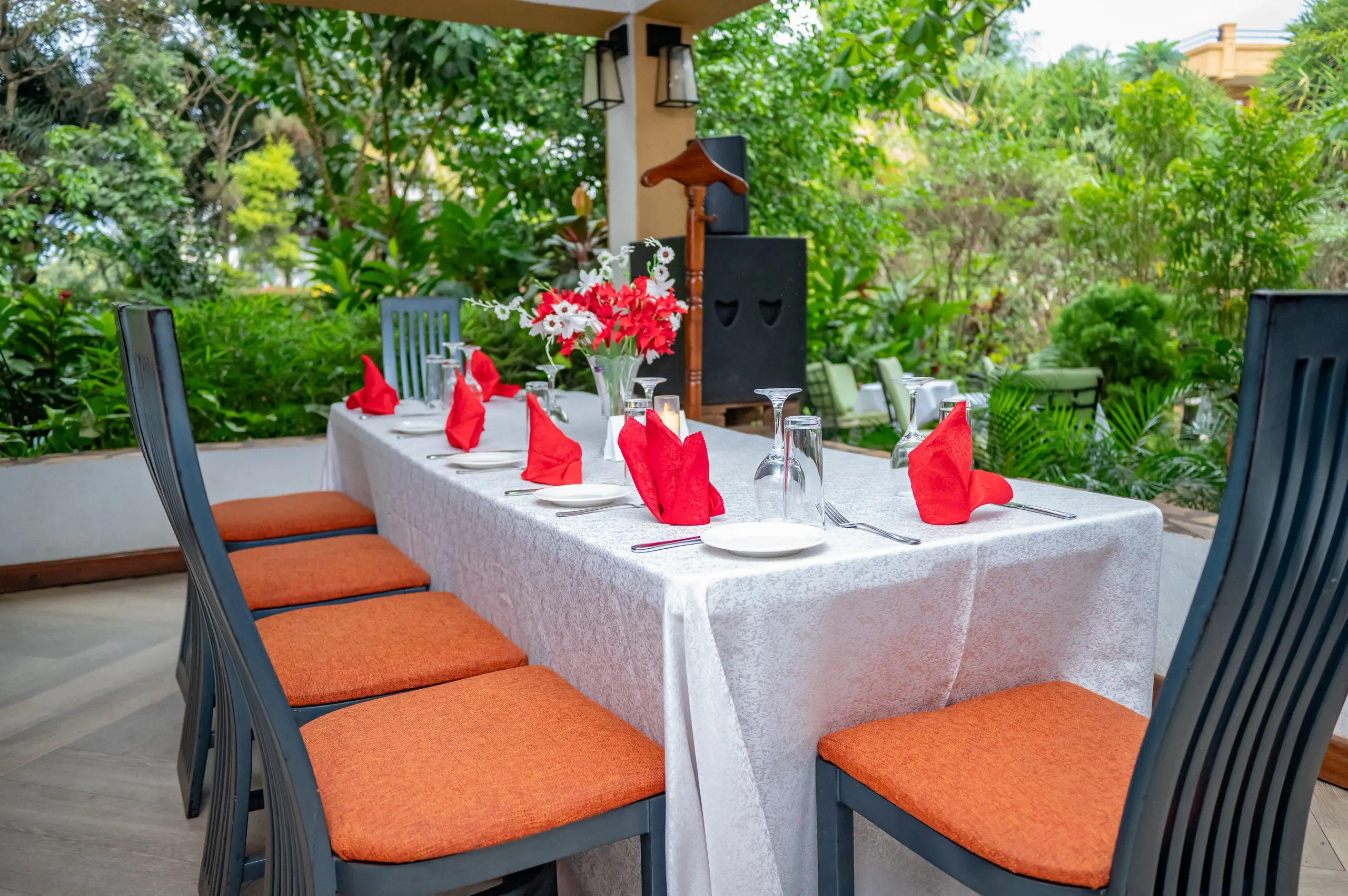 A long table laid on the terrace beside the garden