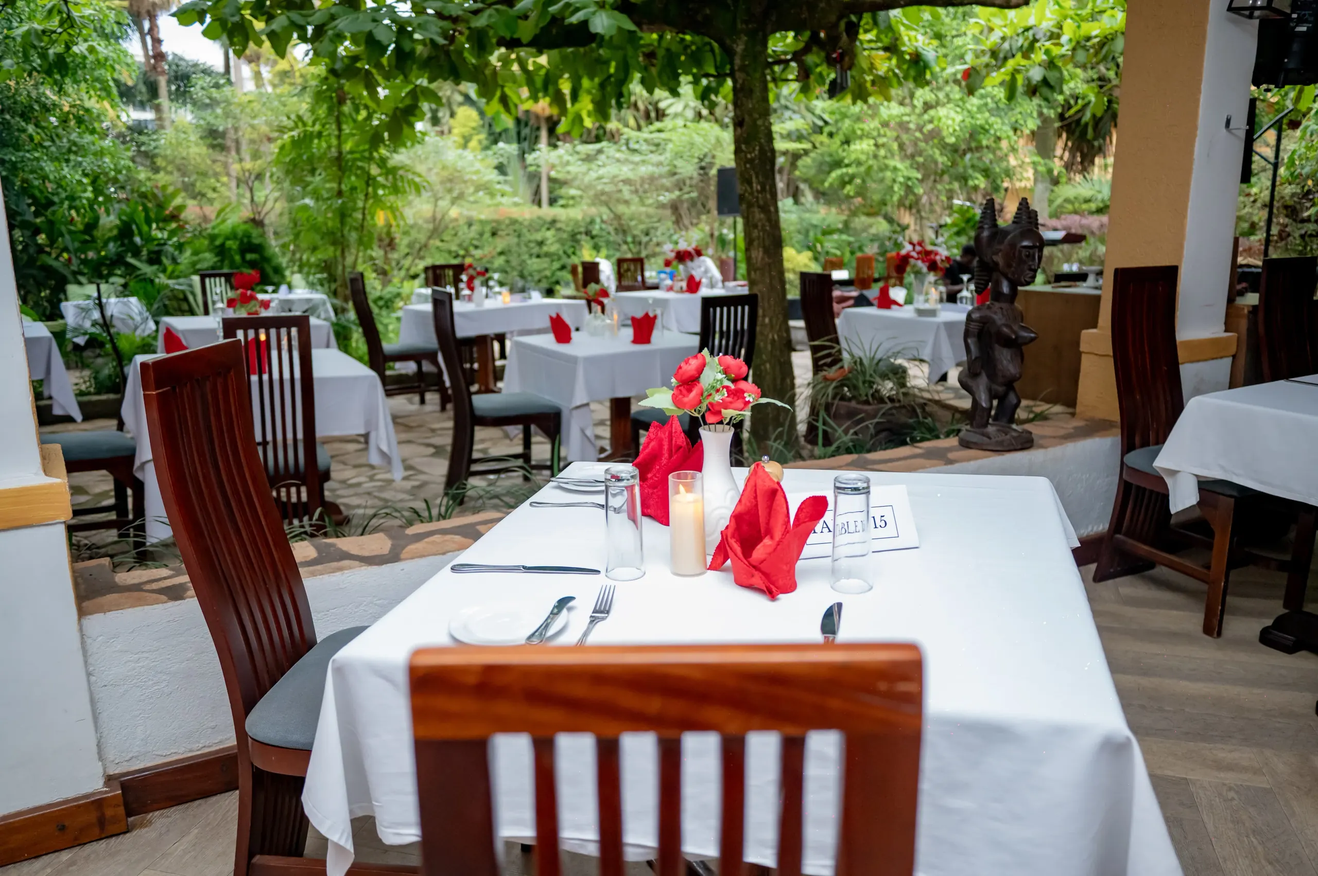 A table laid under the tree in the courtyard