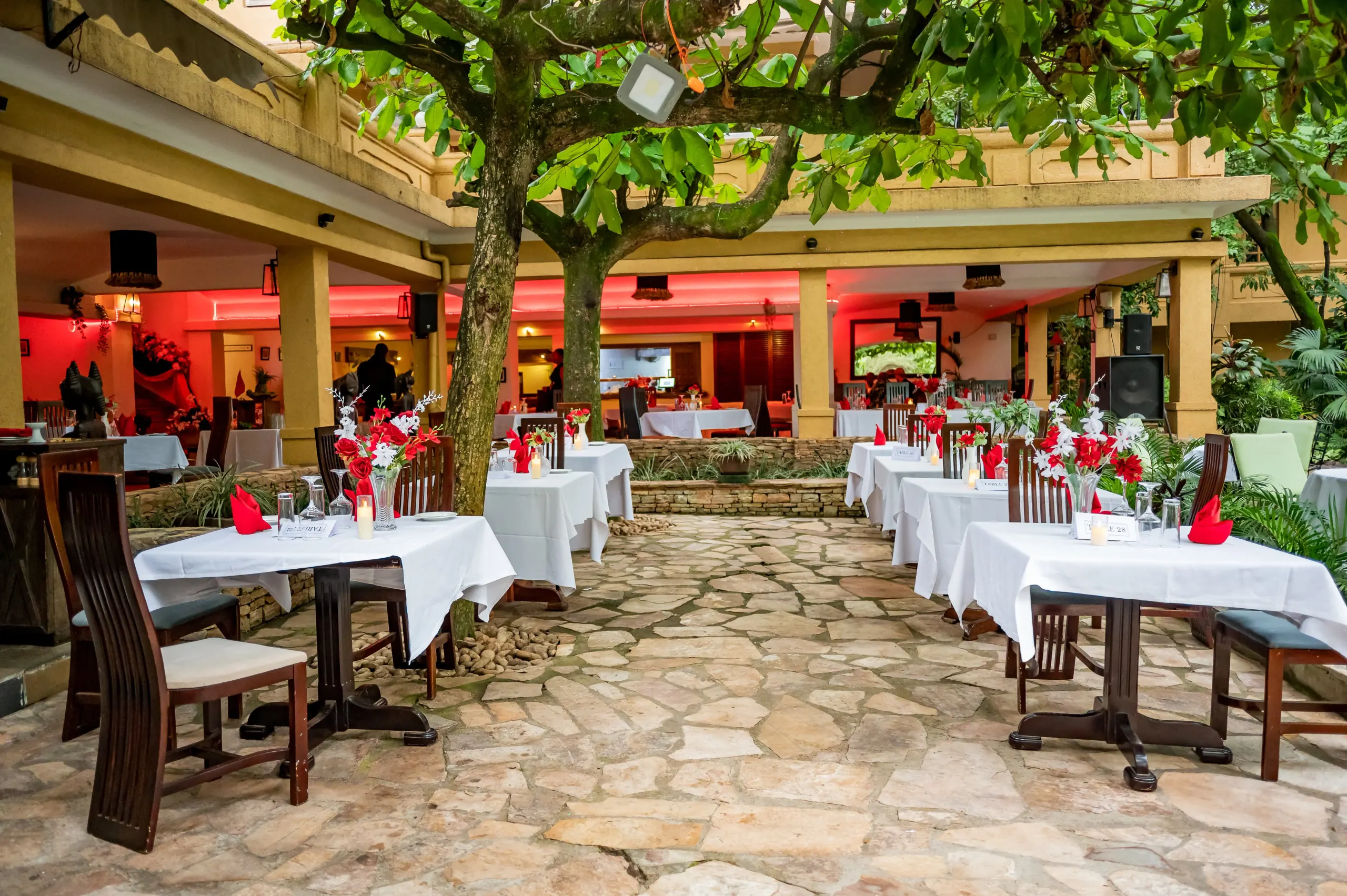 The courtyard at dusk under red lighting