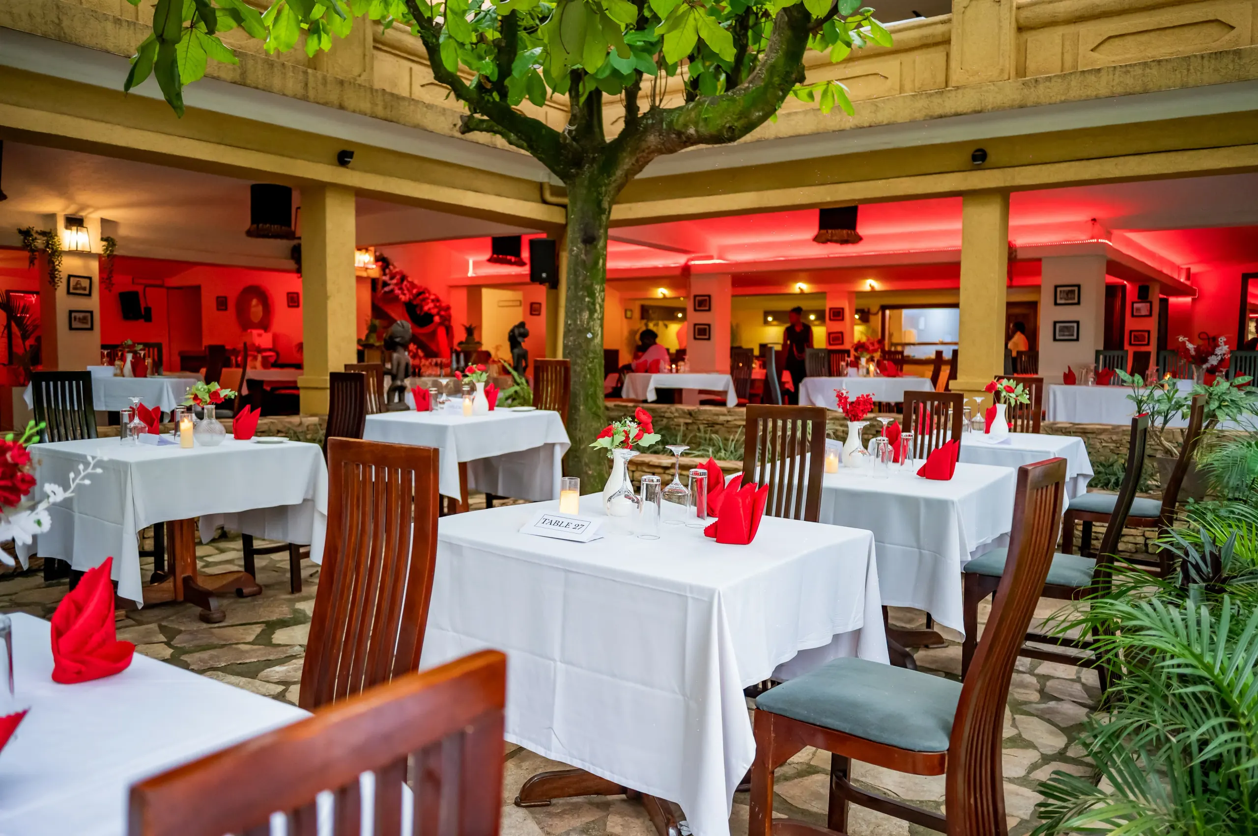 Guests gathering in the colonnade beside the laid courtyard