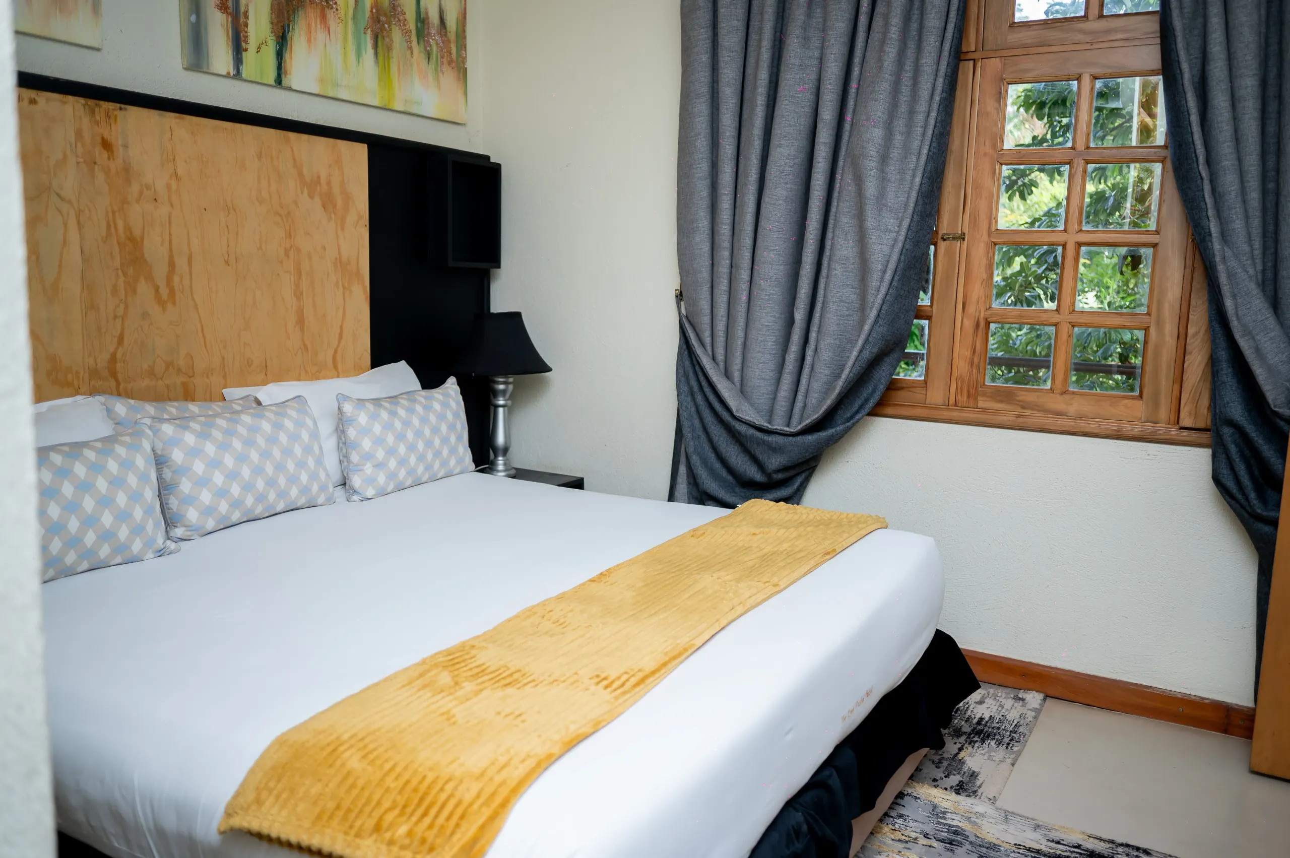 Apartment Room at The Emin Pasha Hotel & Spa, the bed beside a window onto the gardens