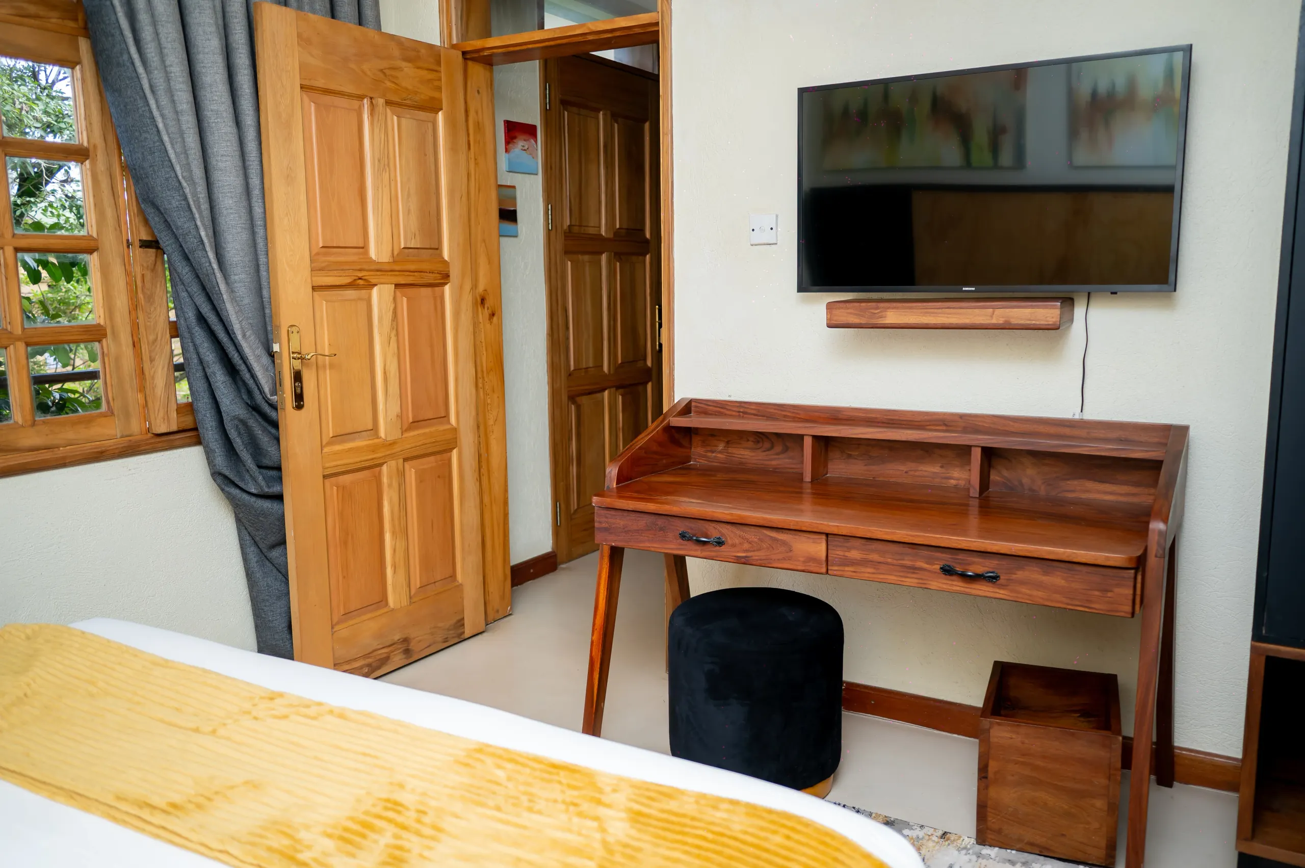 The writing desk and television in an Apartment Room at The Emin Pasha Hotel & Spa